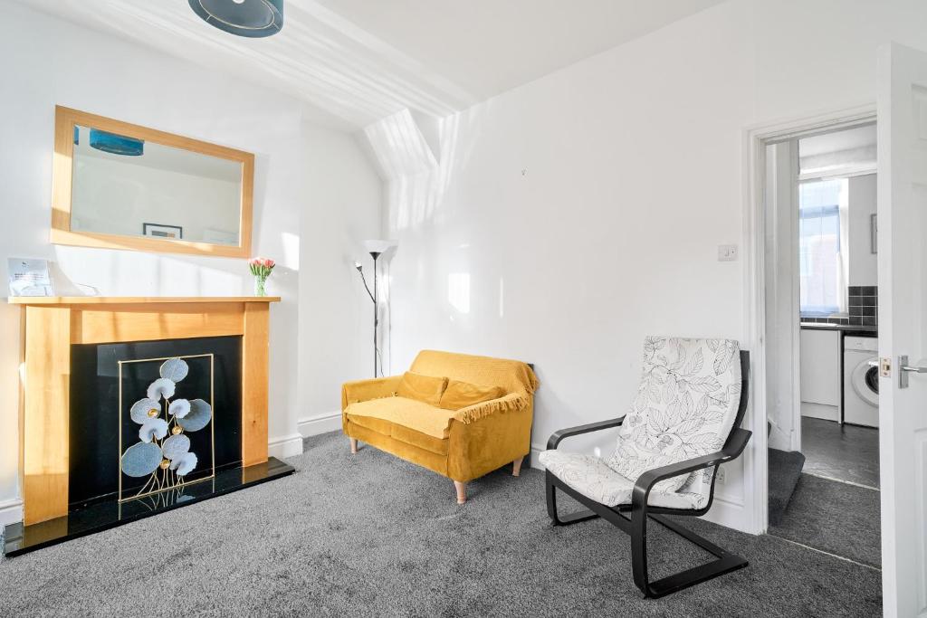 a living room with a chair and a fireplace at Craigs Nook in Darlington
