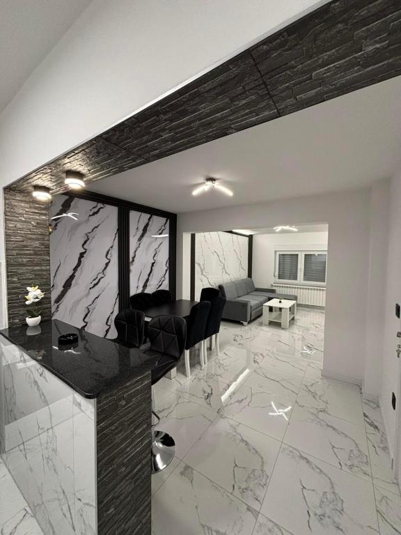 a living room with a marble floor and a couch at Apartman Miljanic in Vlasenica
