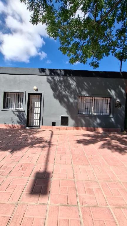 a building with a brick walkway in front of it at Sisters Place in Guaymallen