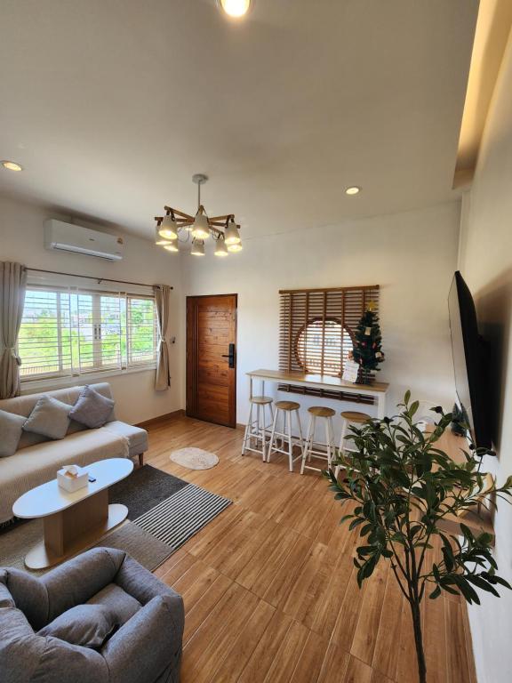 a living room with a couch and a table at 19 House in Ban Khlong Pleo