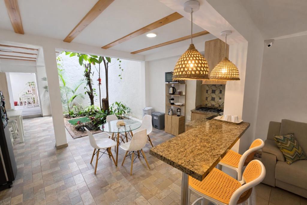 a kitchen and living room with a table and chairs at Casa Mompa in Bucaramanga