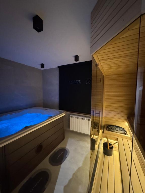 a sauna with a blue tub in a room at Tilia Lux Wellnes &Spa in Čačak