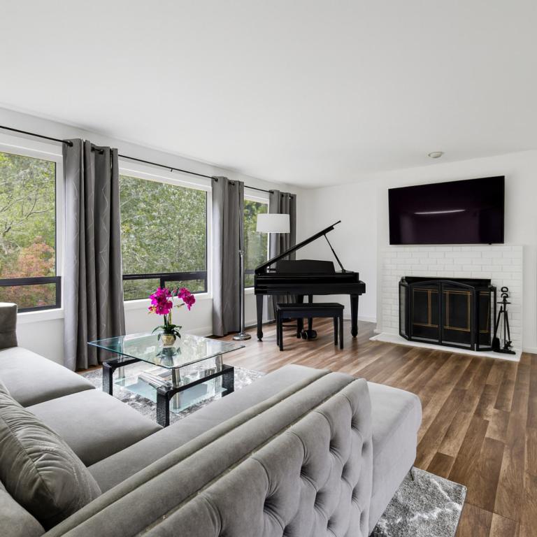 a living room with a couch and a piano at Remodeled, Spacious, Modern Retreat 5 BR, 3BA, 2KIT in Shoreline