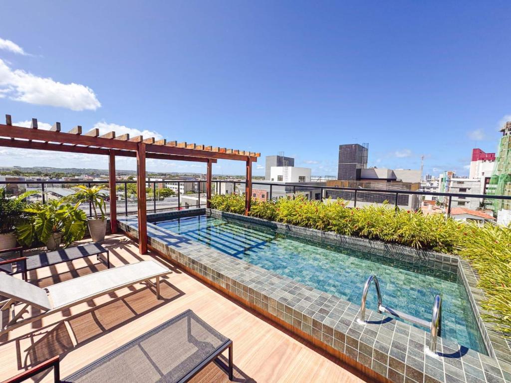 a swimming pool on the roof of a building at FLAT Intermares HUB 105 in Cabedelo