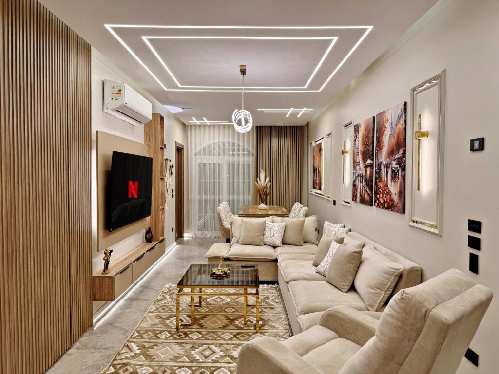 a living room with a couch and a table at Arabella Residence 3BR - New Cairo Luxury Serviced Apartments in Cairo