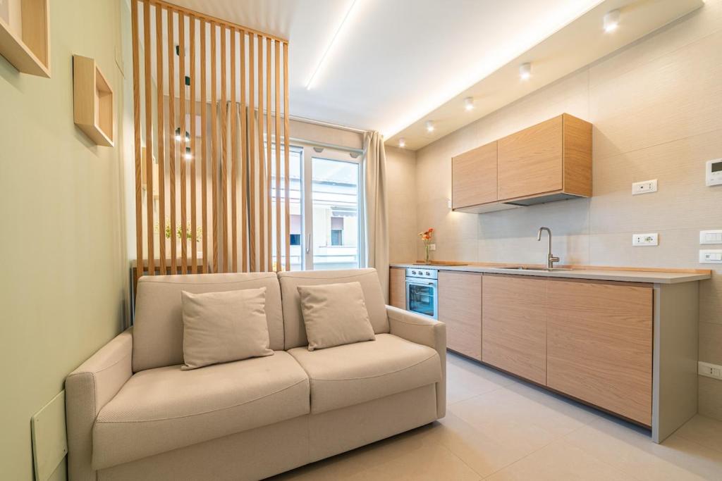 a living room with a couch in a kitchen at Penelope al mare 6 in Alba Adriatica