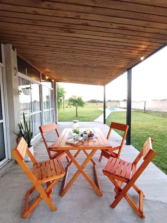 a wooden table and chairs on a patio at Refugio del sol Erezcano in Eréscano