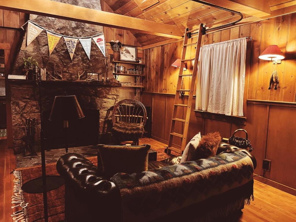 a living room with a couch and a cat sitting on it at Campo Carnelian in Carnelian Bay