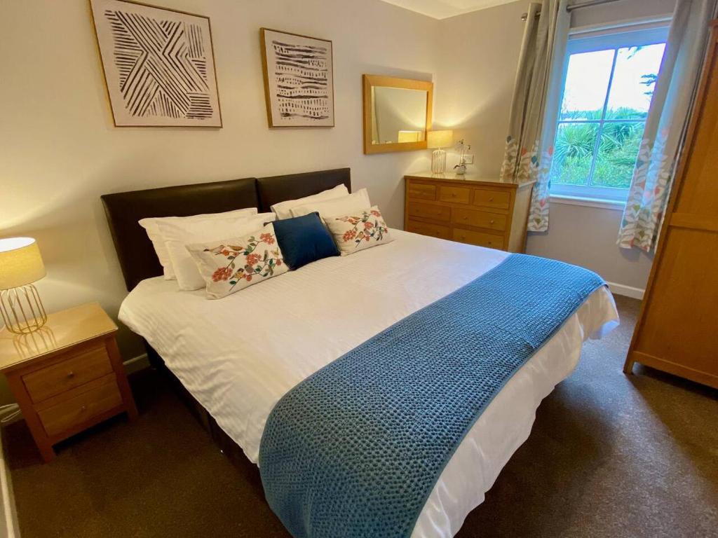 a bedroom with a large bed and a window at Kirkwall town centre apartment 3 in Kirkwall