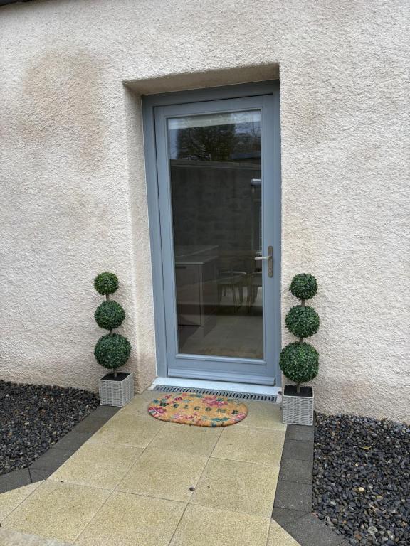 a glass door with a mat in front of it at Neds Barn in Galway