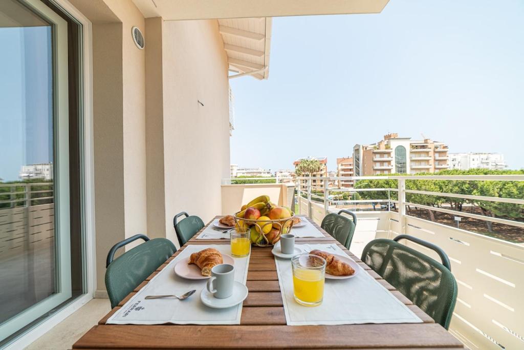 a table with breakfast food on a balcony at Penelope al mare 20 in Alba Adriatica
