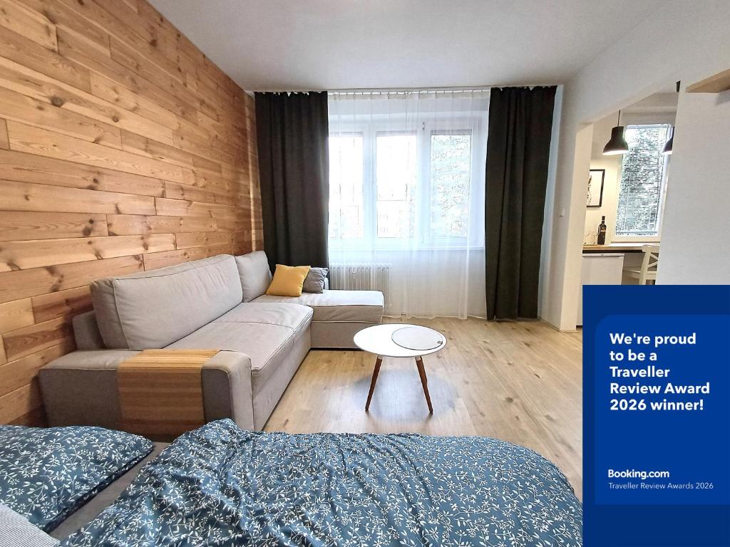 a living room with a couch and a table at Apartman Point in Štrba