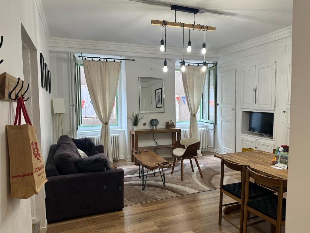 a living room with a couch and a table at Aroma Cite Vauban in Briançon