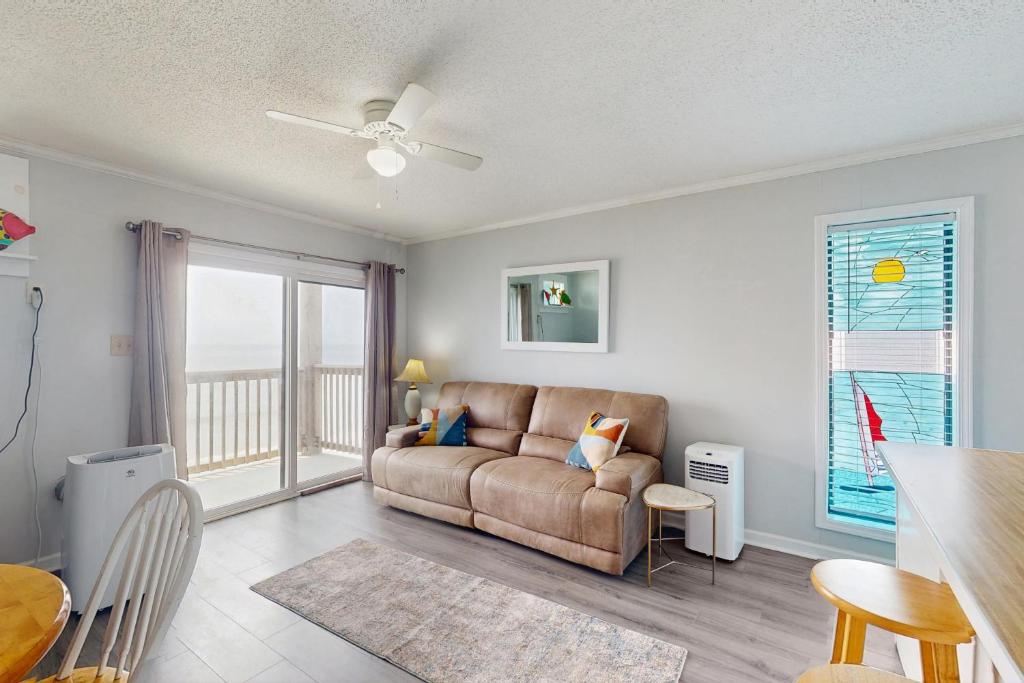 a living room with a couch and a table at NTBTR329 Totally Topsail in North Topsail Beach