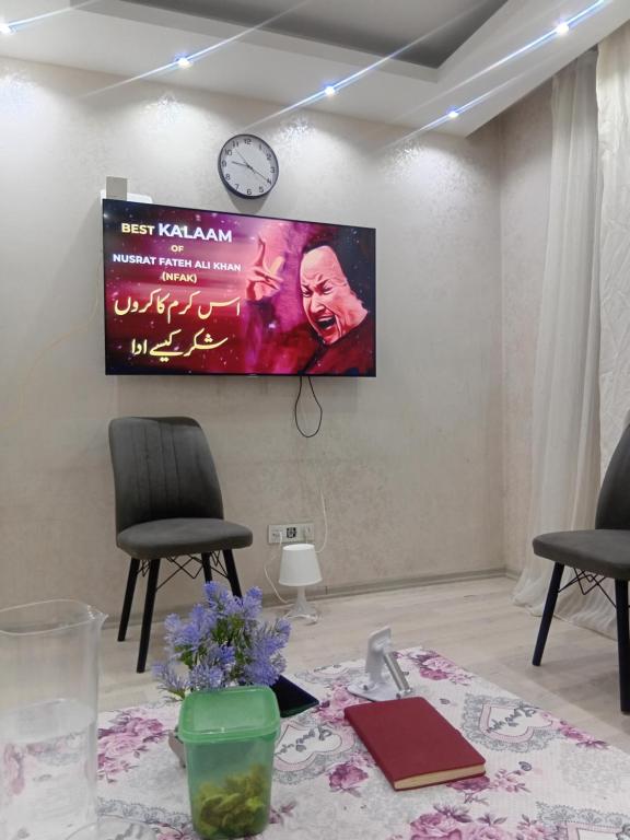 a flat screen tv hanging on a wall at Edebiyat Apartments in Istanbul