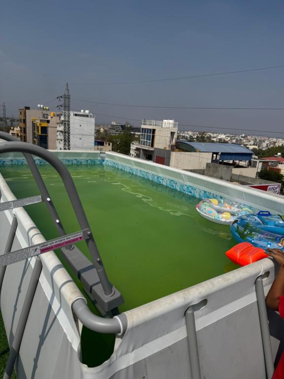 a swimming pool on top of a building at LUXE Penthouse 4BHK with Swimming pool in Mysore