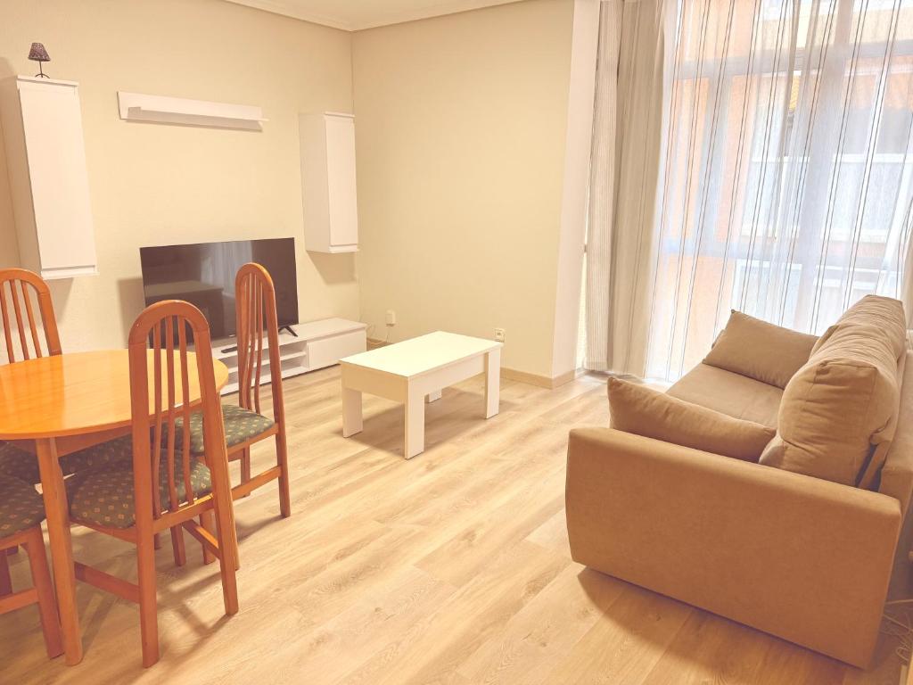 a living room with a couch and a table at Caballeros 7 in Soria