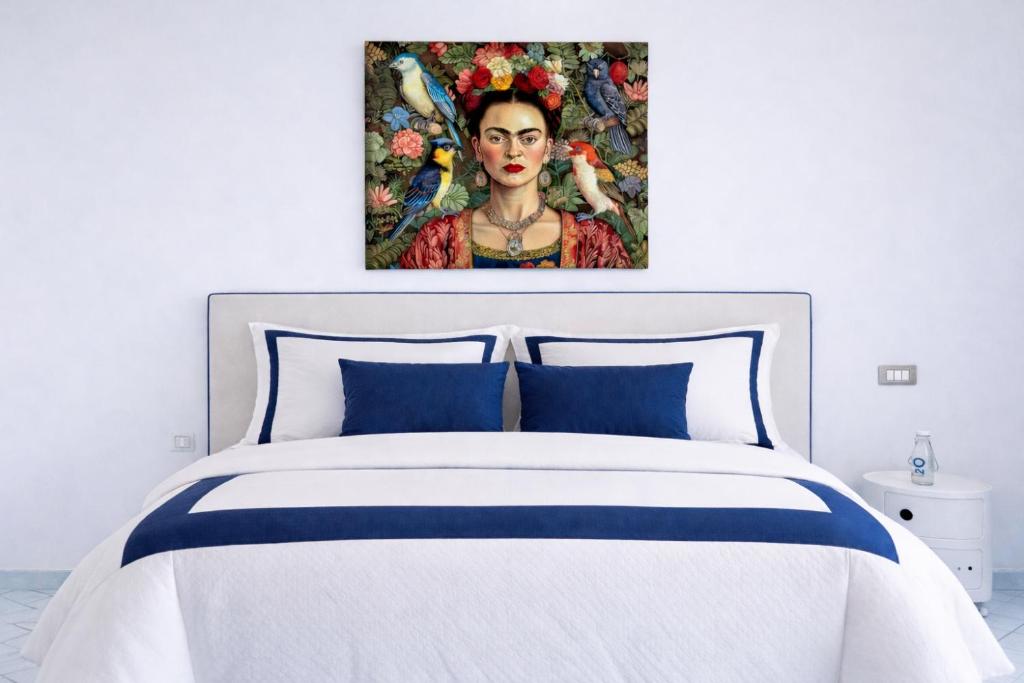 a bedroom with a bed with a painting of a woman at Appartamento Corso Italia 269 in Sorrento