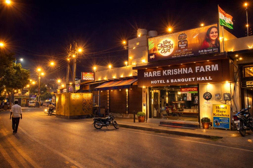 a man walking down a street at night at Hotel Hare Krishna & Banquet, Vrindavan in Vrindāvan