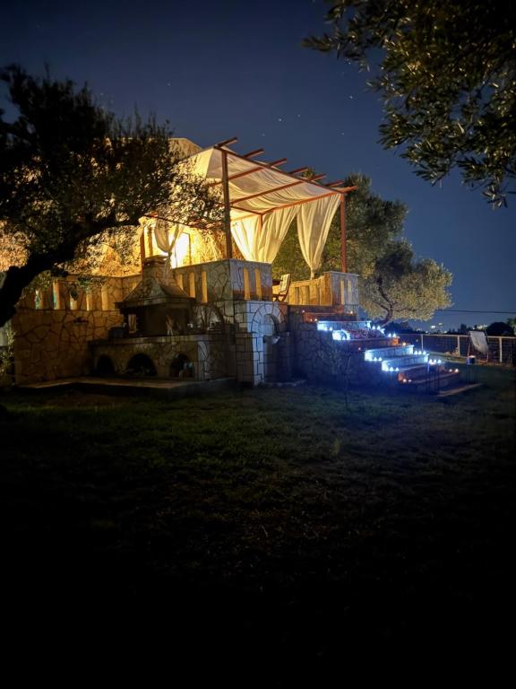 a building lit up at night with lights at oleabungalows in Akrotiri