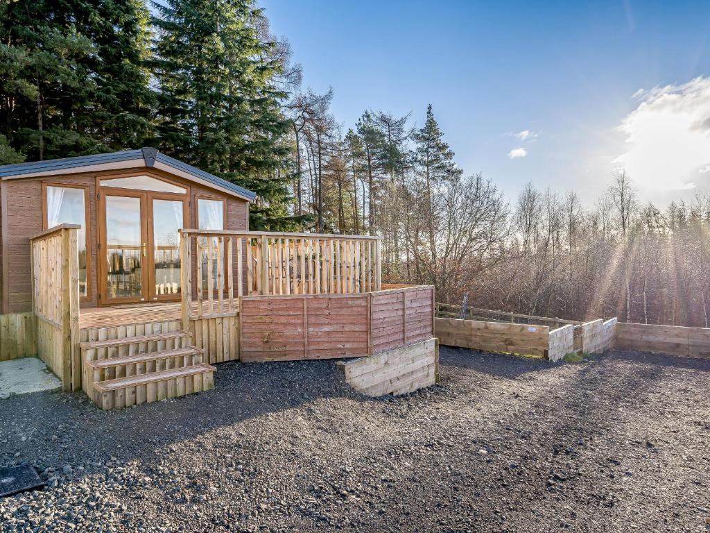 a small wooden cabin with a gazebo at The Paddocks - Uk7112 in Alloa