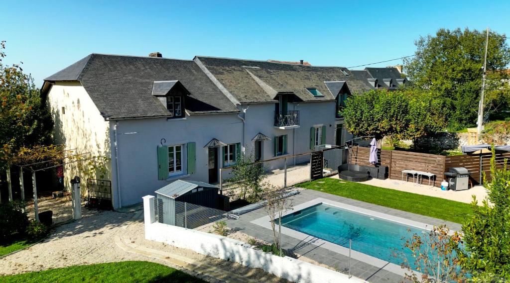 an aerial view of a house with a swimming pool at Pause Pedal Pyrénées in Capvern