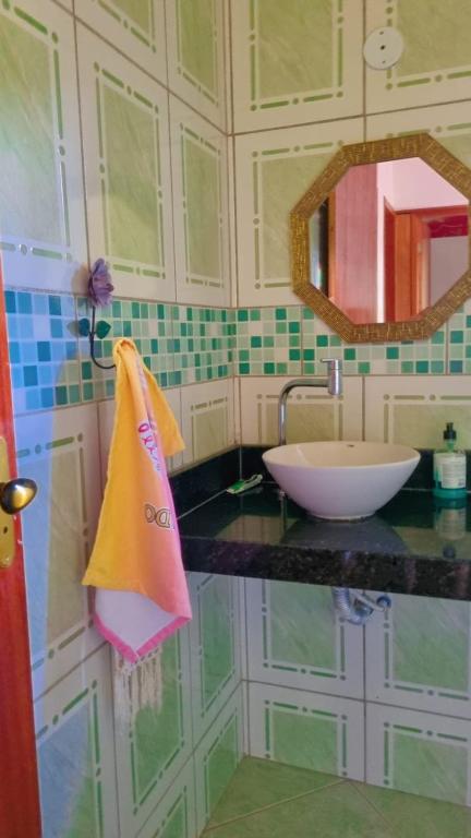 a bathroom counter with a sink and a mirror at Sitio Ziriguidum in Nova Friburgo