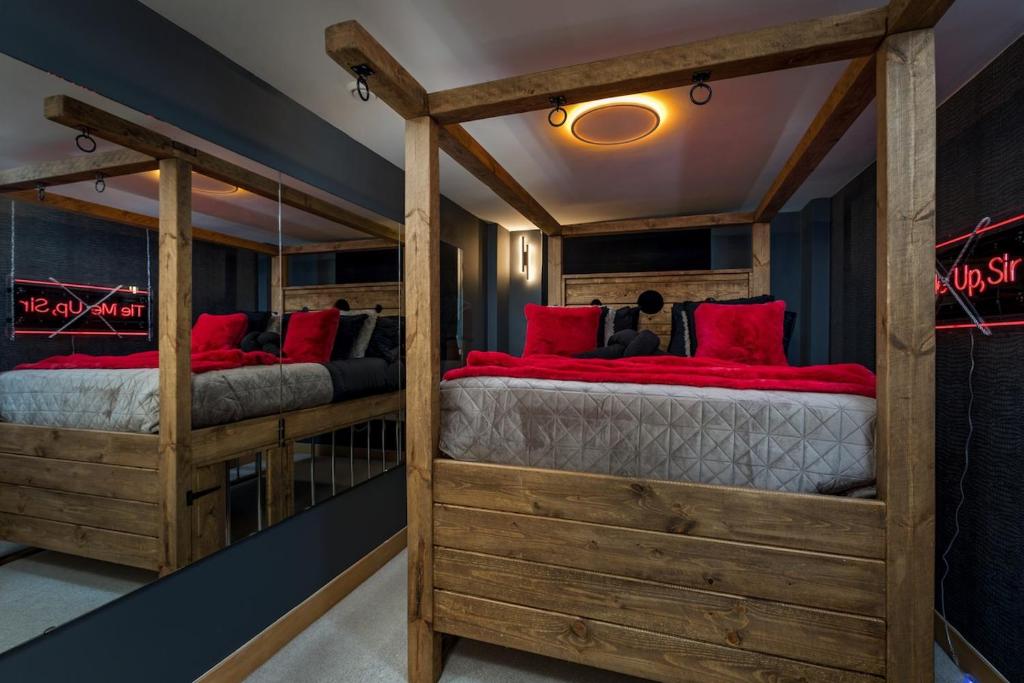 two bunk beds with red pillows in a room at The Midnight Parlour in Leeds