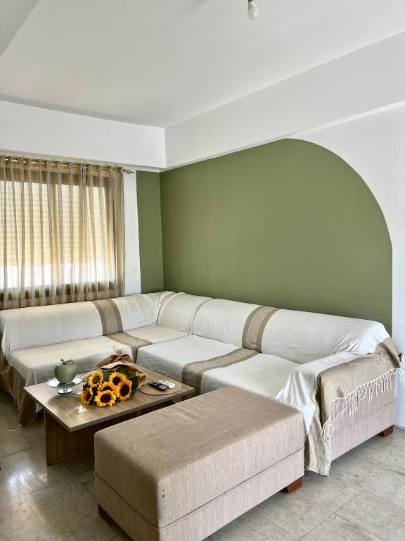 a living room with a couch and a table at Comfortable and Fresh Apartment in Tunis