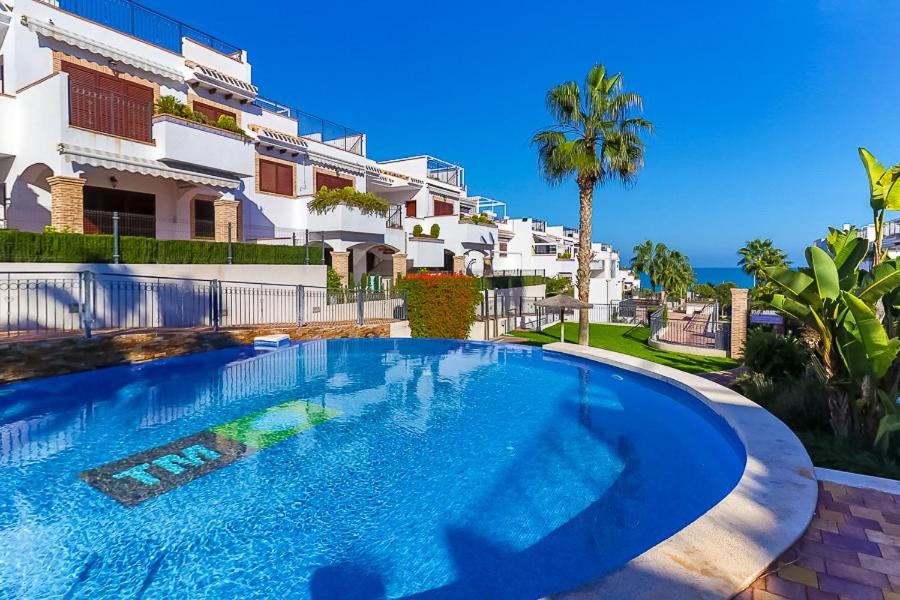 a large swimming pool in front of a building at Lazy Wave Apartment in Torrevieja