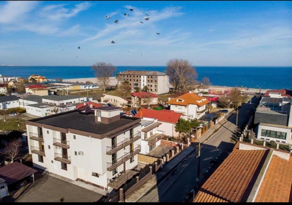 an aerial view of a city with buildings and the ocean at Tropical Beach in Eforie Sud