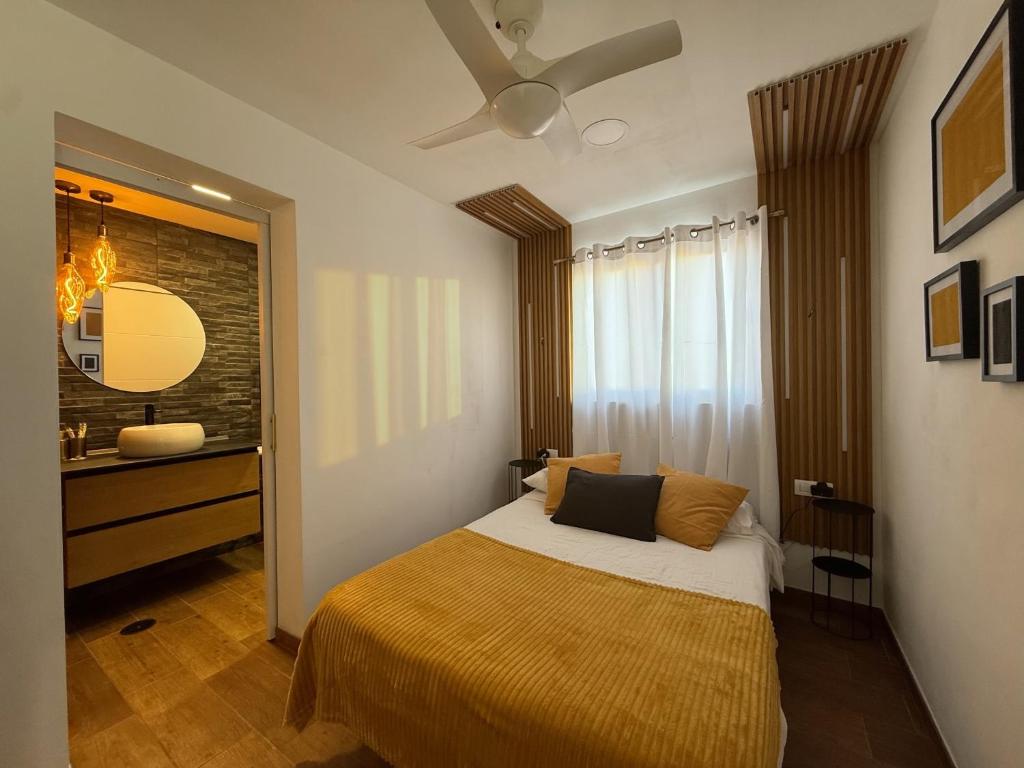 a bedroom with a bed and a dresser and a mirror at Candela 2 en candelaria in Candelaria