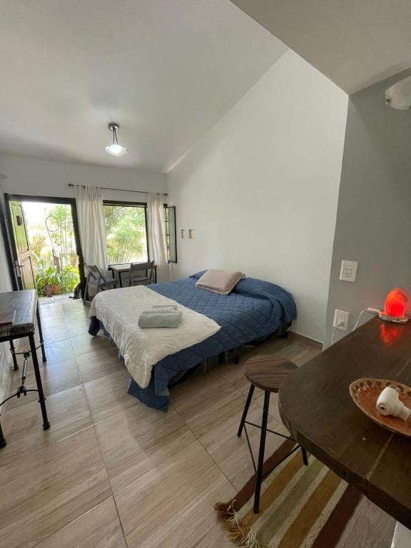 a bedroom with a bed and a table at Casa laberinto, Entre cerros, cómoda cama de 2x2 in Salta