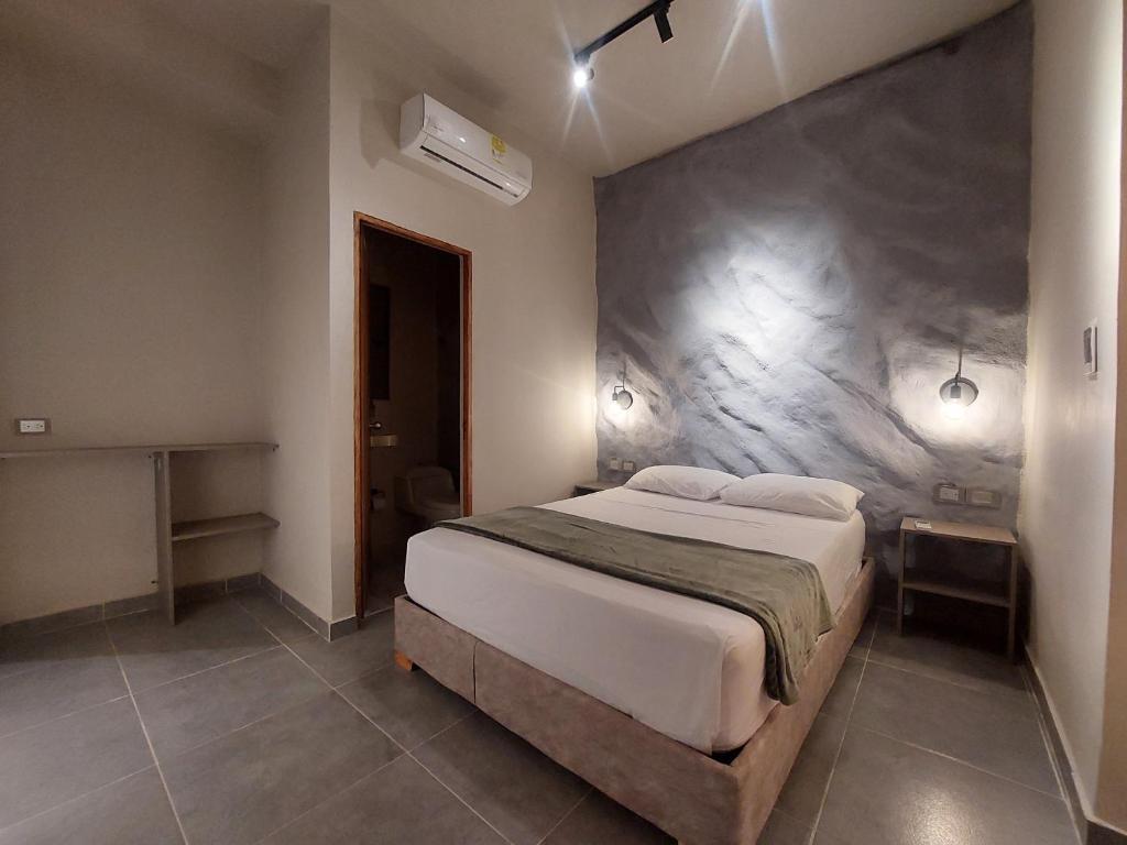 a bedroom with a large bed in a room at Hotel Kyros by 70 in Medellín
