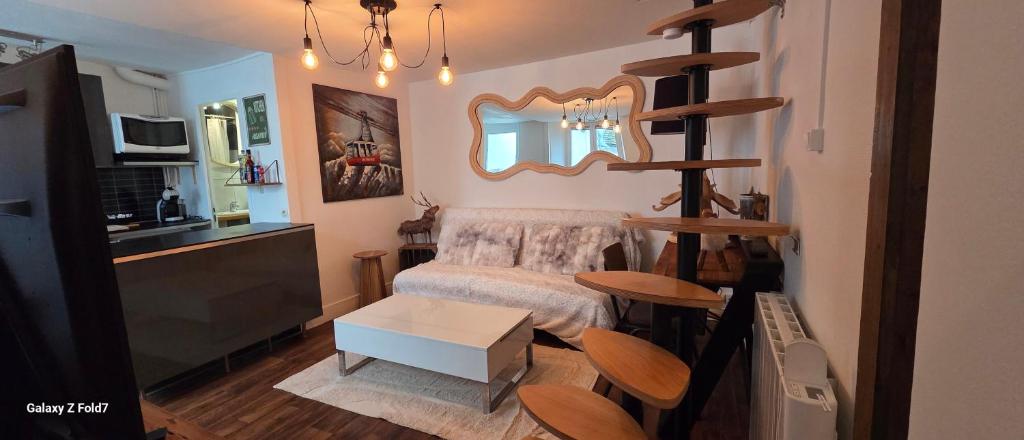a small room with a bed and a table at La cachette de l'Alpiniste in Fontainebleau