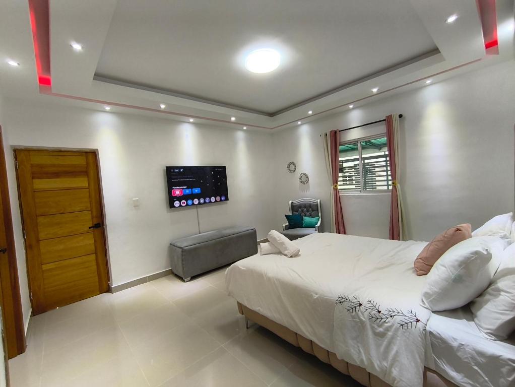 a bedroom with a bed and a flat screen tv at América Colares VII in Los Frailes
