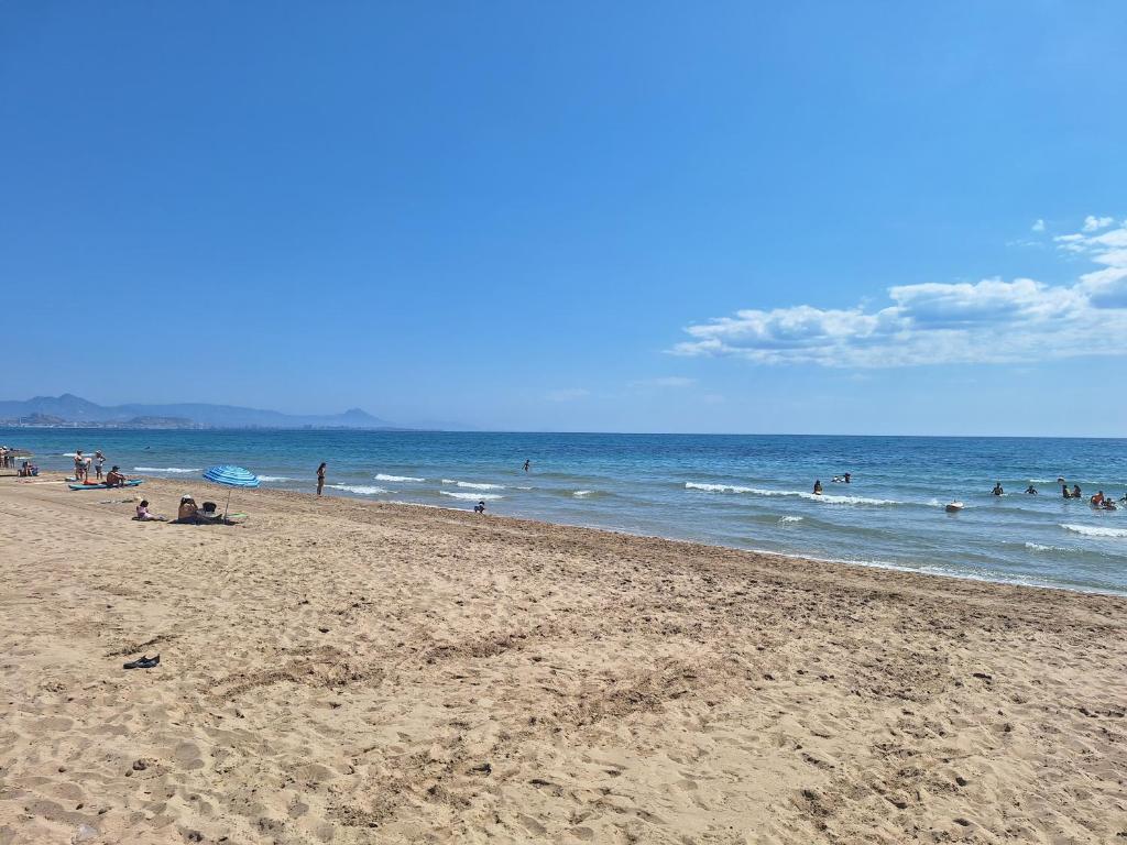 a group of people on a beach with the ocean at Carabassi playa in Gran Alacant
