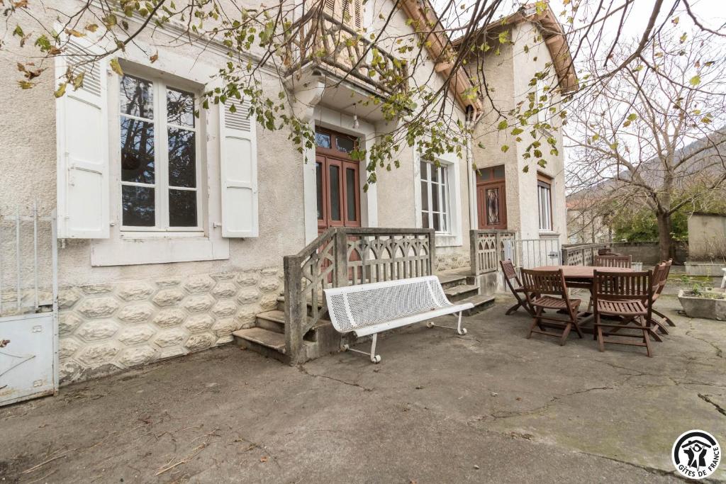 a house with a table and chairs on a patio at Maison de Marius et Maison d Amelie in Esténos