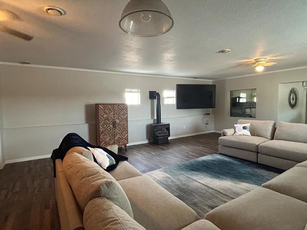 a living room with a couch and a flat screen tv at The Palace in Mandan