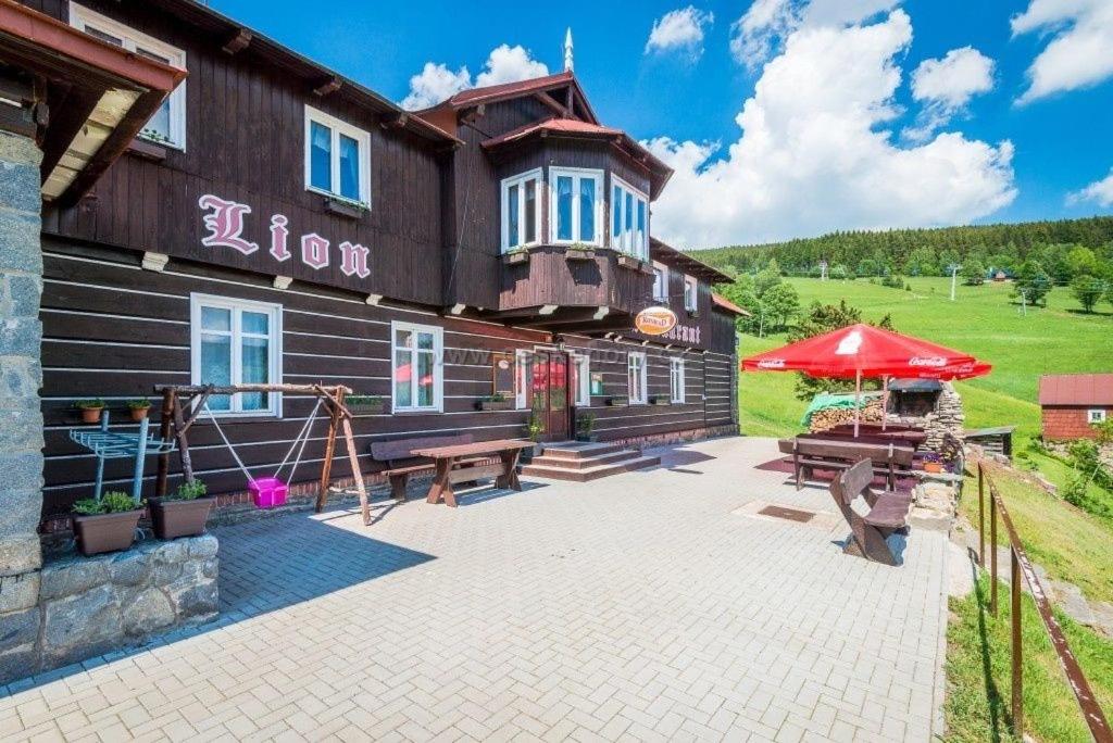 a building with a playground in front of it at Chata Lion in Pec pod Sněžkou