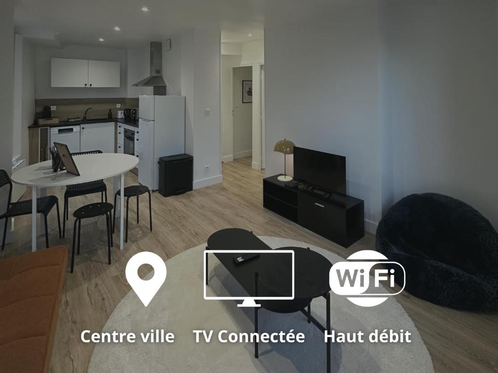a living room with a tv and a table and chairs at L'écrin orange, Wifi et parking gratuit in Chalons en Champagne