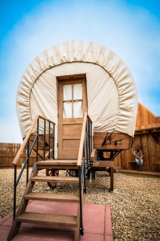 a yurt with a ladder and a door and a ladder at Big Texan Wagons in Amarillo