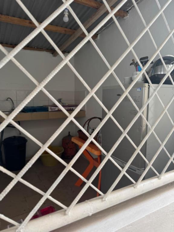 a view of a kitchen through a white latticedcyclop at Simple house in Lyndiane Zig in Ziguinchor