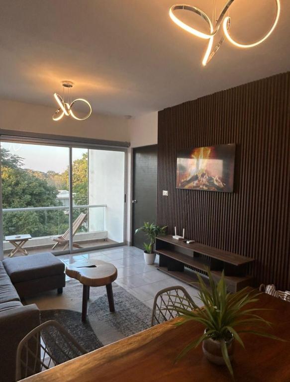 a living room with a couch and a table at Apartamento con acceso directo al río in Veracruz