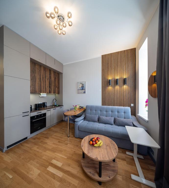 a living room with a blue couch and a table at Premium Design, Renovated 2024 Free parking in Riga