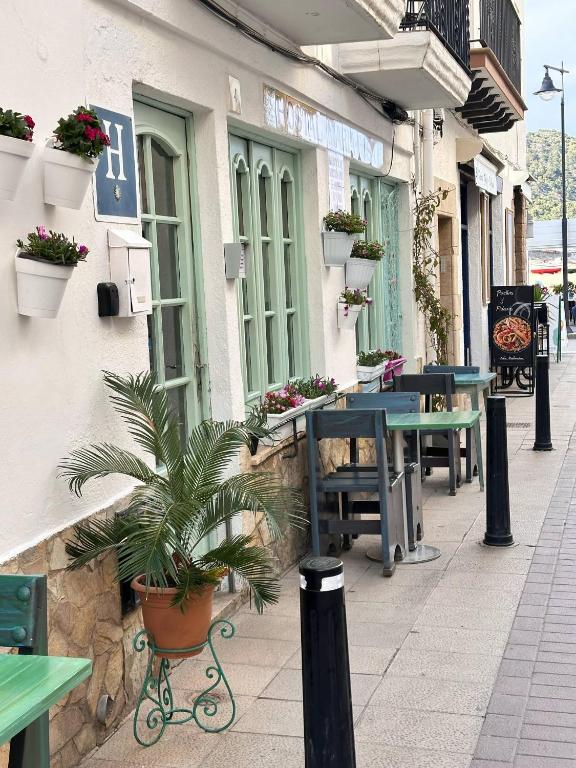 a row of tables and benches outside of a restaurant at P&R hostals Maria Rosa in Tossa de Mar