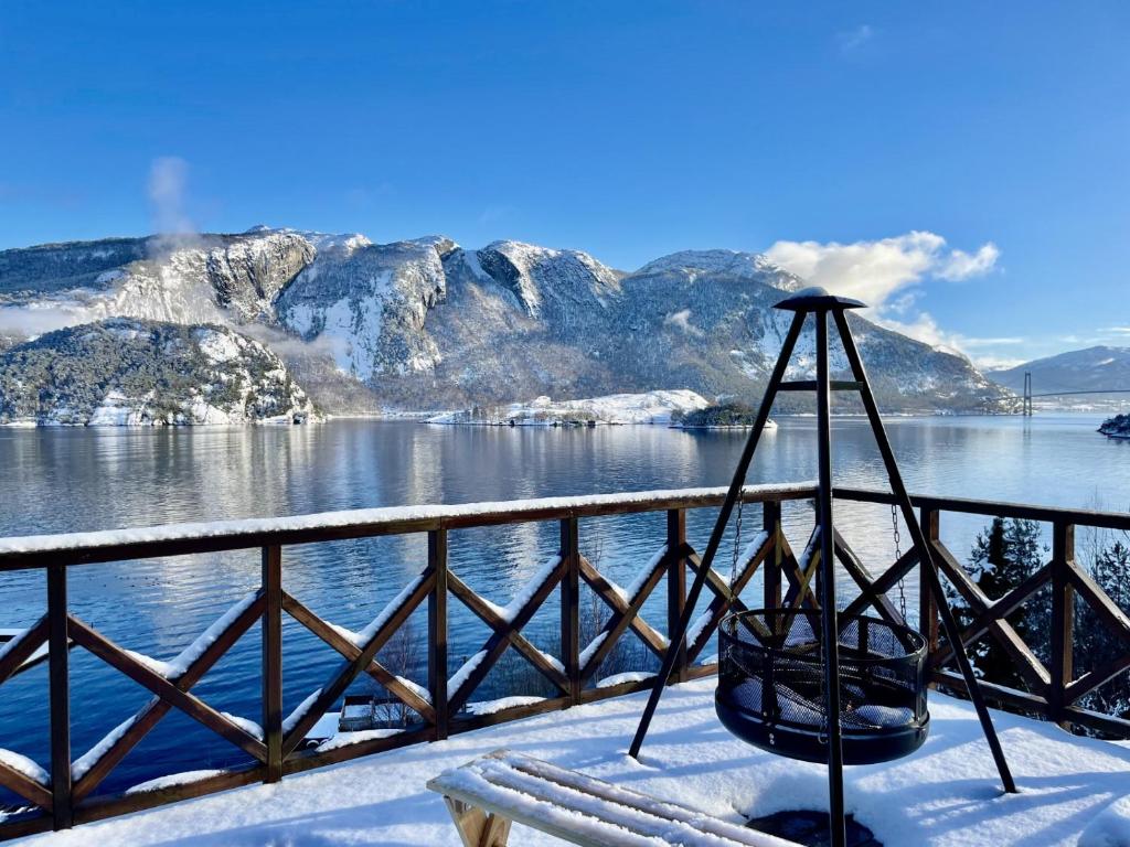 a view of a body of water with snow covered mountains at FjordCabin Preikestolen in Strand