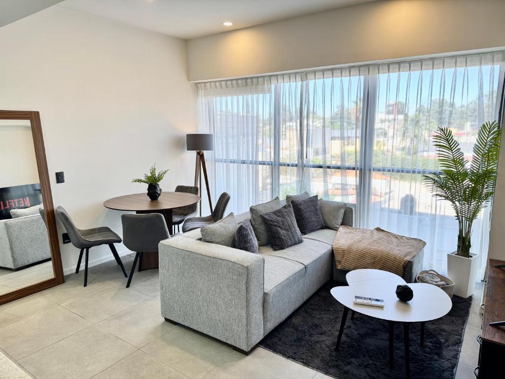 a living room with a couch and a table at Luxury apartment near Andares in Guadalajara