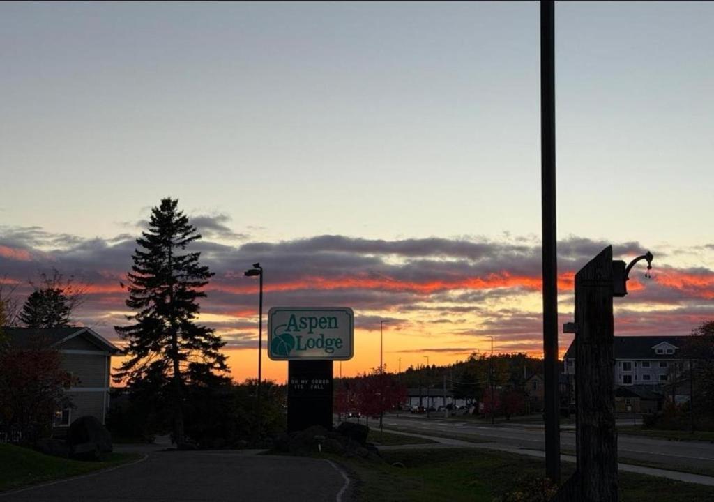 an asian village sign in front of a sunset at Aspen Lodge in Croftville