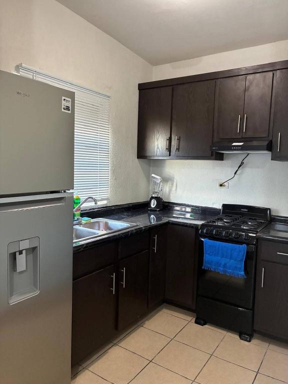 a kitchen with a refrigerator and a stove top oven at Modern 2-Bedroom House in Guaymas in Guaymas